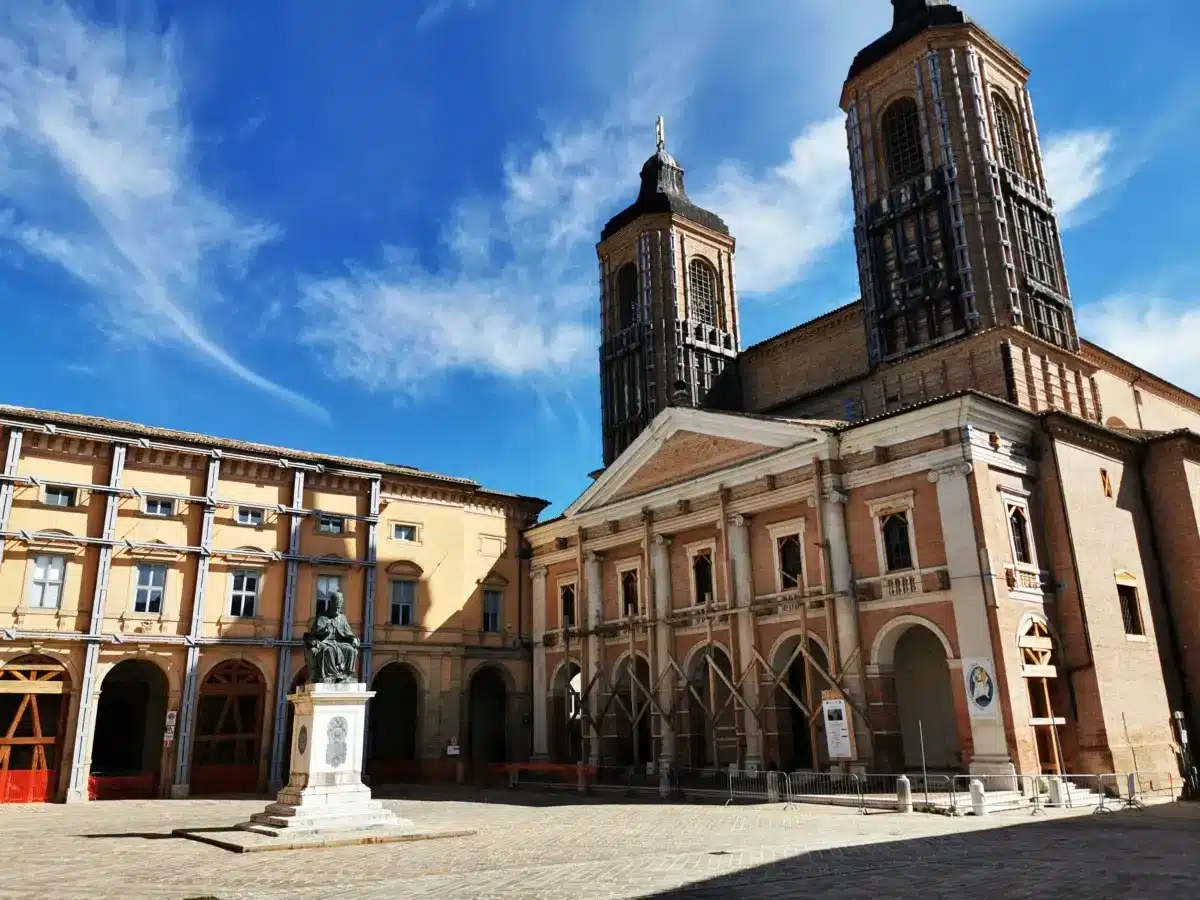 Piazza Cavour in Camerino with the cathedral towers and the bronze statue of Pope Sixtus V