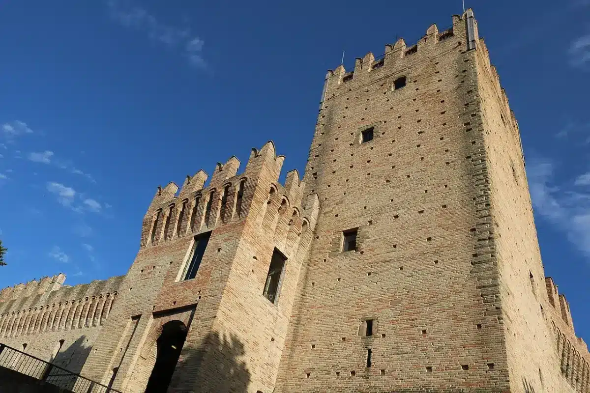 Crenellated brick walls and tall keep of Castello della Rancia near Tolentino