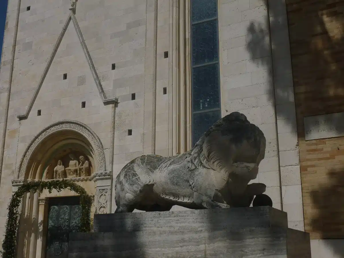 Romanesque-Gothic stone facade of Fermo Cathedral on Girfalco hill with a stone lion