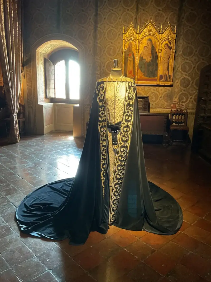 Medieval-style gown displayed in Francesca room inside the Rocca di Gradara castle
